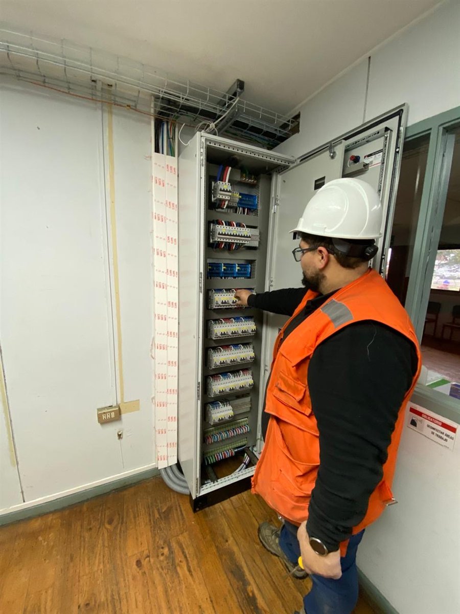 Técnico de Redelectric operando sobre un tablero de distribución en planta papelera